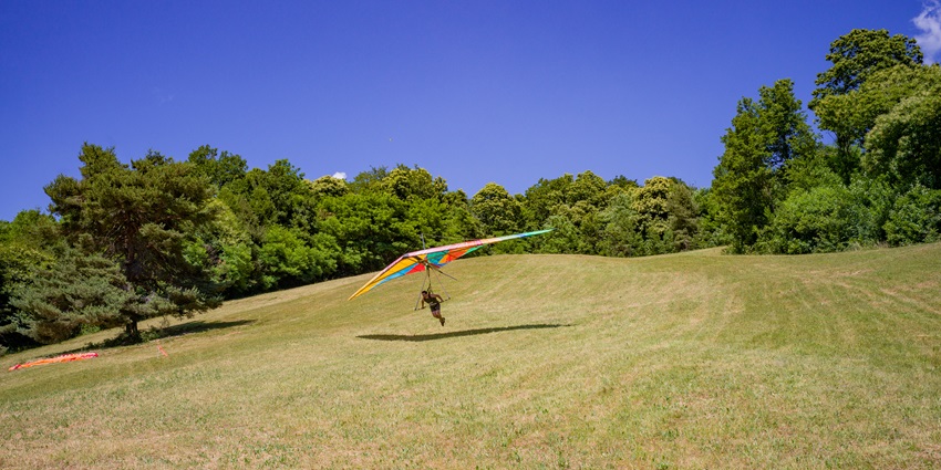 A picture of a person enjoying hang gliding at the lush green valleys in Sikkim