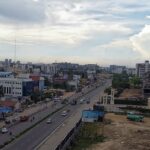 A picture of the city skyline with a train on tracks, showcasing Chennai city, Tamil Nadu.