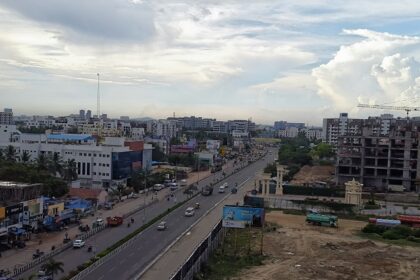 A picture of the city skyline with a train on tracks, showcasing Chennai city, Tamil Nadu.