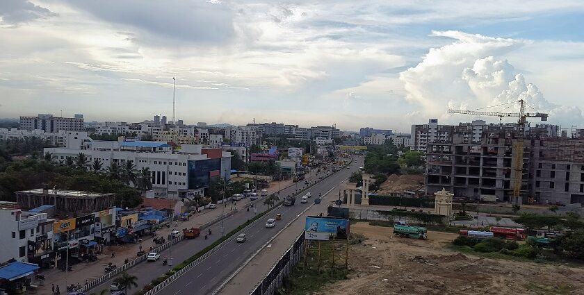 A picture of the city skyline with a train on tracks, showcasing Chennai city, Tamil Nadu.