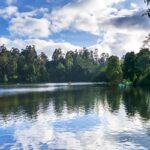 A picture of a beautiful lake and view, rippled water reflecting the blue colour sky.