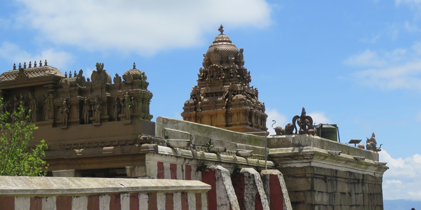 Peaceful hilltop view of Gopalaswamy Temple surrounded by mist and forested landscape.