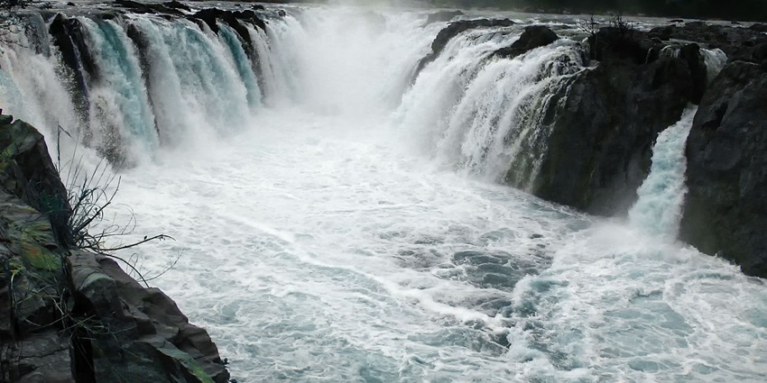 An image view of the majestic Hogenakkal Falls cascading dramatically into the river below.