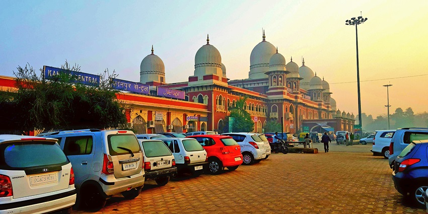 A wide-angle view of Kanpur Central Station in Uttar Pradesh, India, showing people walking.