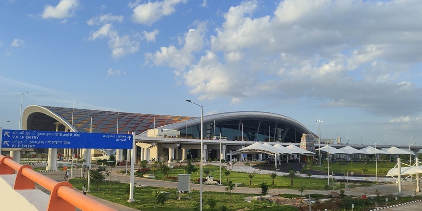 An outer view of the Tiruchirappalli International Airport is showcased from a distance.