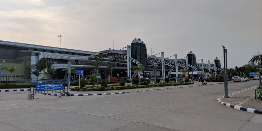 Tiruchirappalli International Airport entrance with a modern glass facade and visible sign.