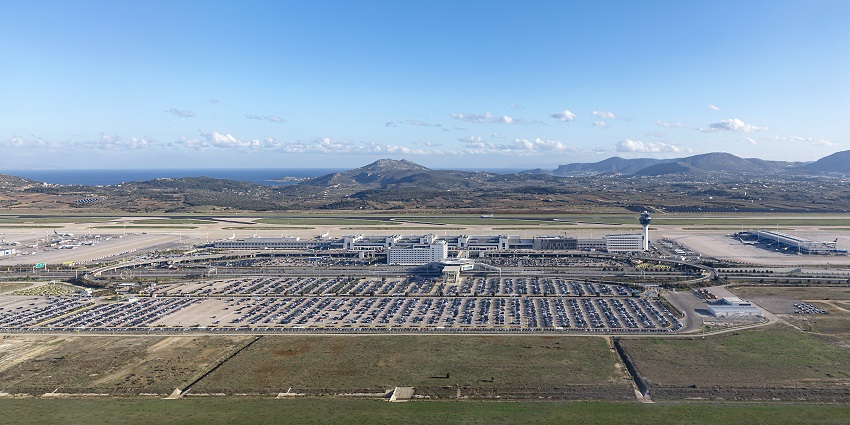 Athens International Airport area with its runway, parking lot and modern architecture.