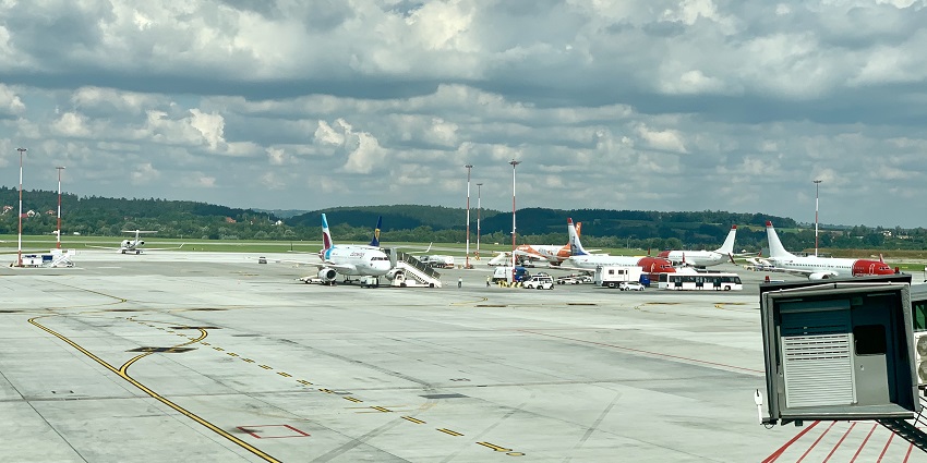 Kraków John Paul II International Airport well lit at night with modern architecture.