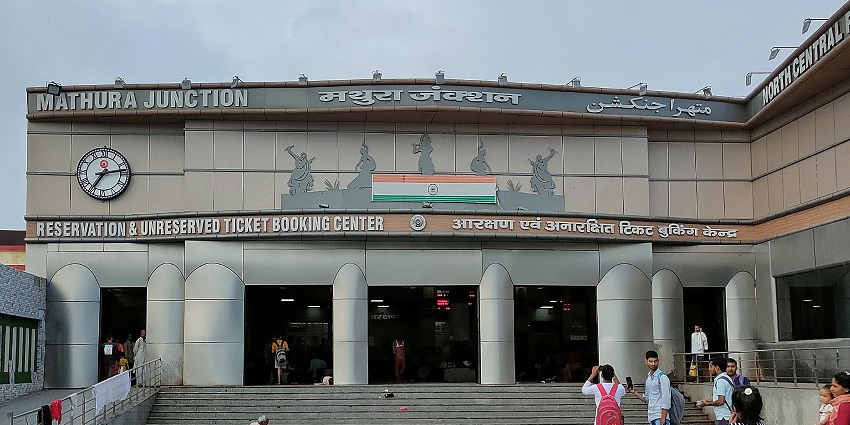 An image of Mathura Junction Railway Station, showcasing trains and passengers in transit.