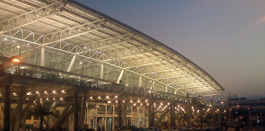 Chennai International Airport with modern structure, and cars parked outside the building