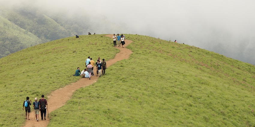 Trekking trail leading to scenic mountain views under the clear blue sky
