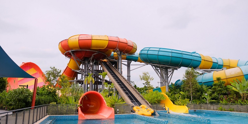 Image of the vibrant slides and a swimming pool in the park