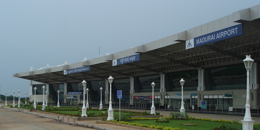 An exterior view of the Madurai Airport terminal building with visible entrance signage.