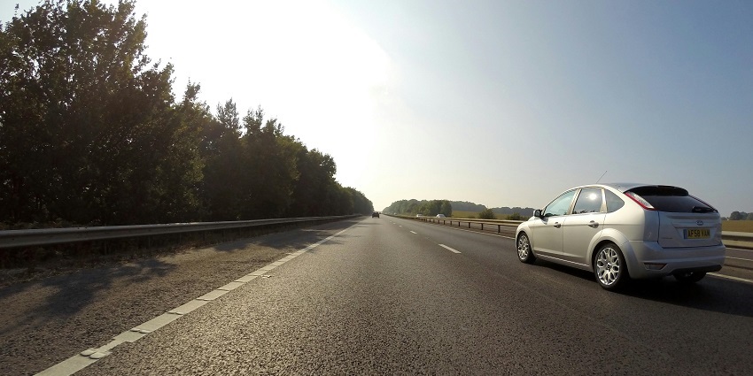 The view of the car on a road driving towards Aligarh Fort during the early evening.