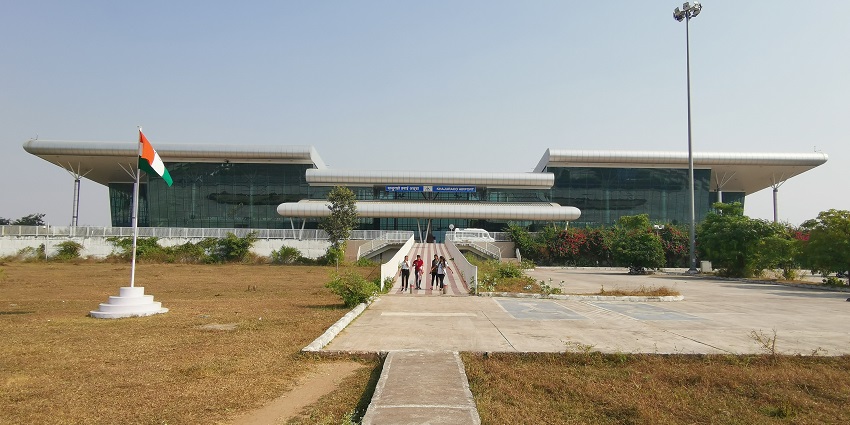 Khajuraho Airport terminal with clear blue skies and modern architectural design.