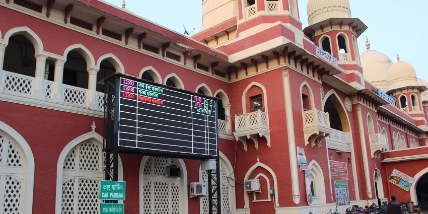 A picture of the Central railway station of Kanpur city with a board displaying train timings