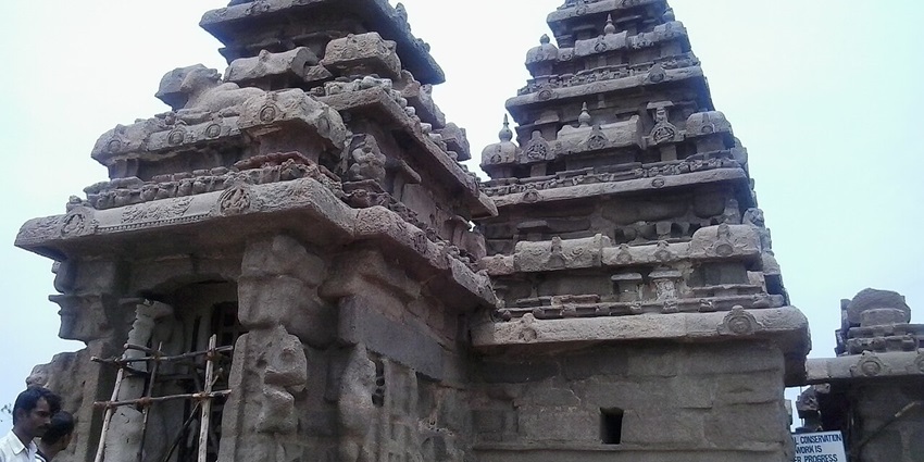 One of the 5 ancient Rathas, located inside the Ratha Temple with 2 people looking at it.