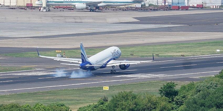 A picture of an aeroplane landing on a runway at an airport near Thiruvenkadu Temple