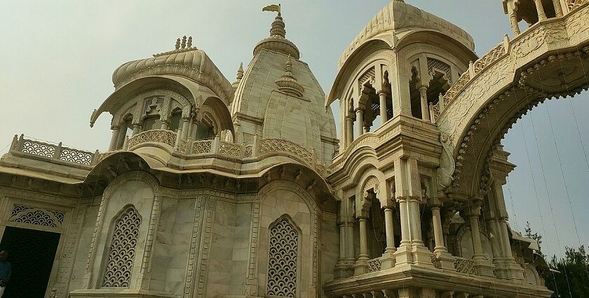 Vibrant Sri Krishna Balaram Mandir with ornate architecture, colorful decorations, and a lively atmosphere