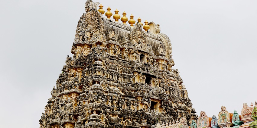 Image of temples near the waterfront at dusk, similar to Immayil Nanmai Tharuvar Temple