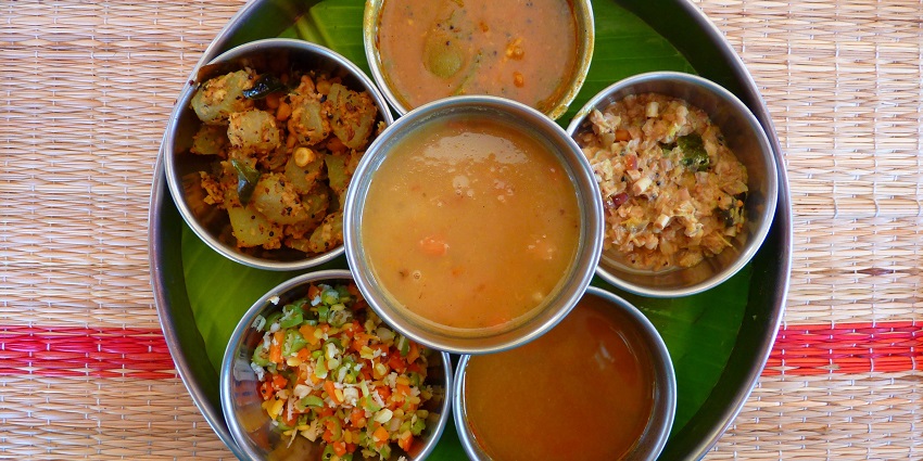 A glimpse of a thali with many dishes being served on a bamboo platter in Uttarakhand.