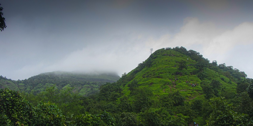 A picture of Irshalgad pinnacle with rugged terrain and surrounding valleys.