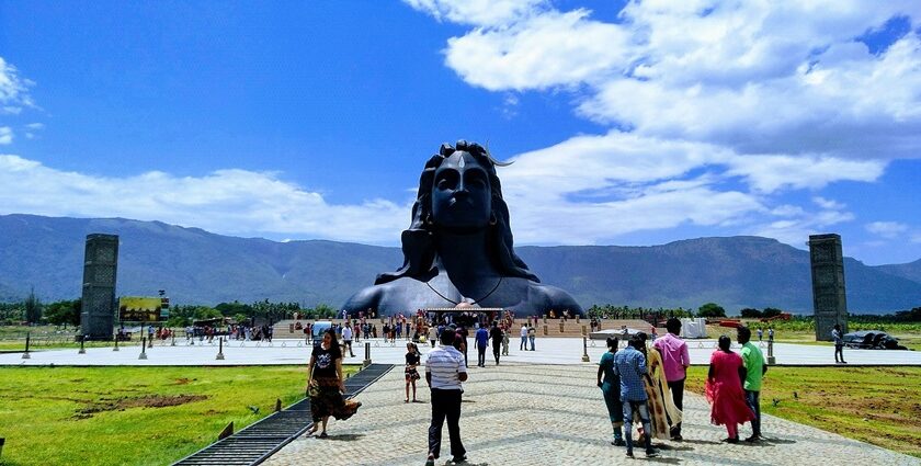 Isha Temple with the backdrop of the Velliangiri Mountains and clear blue skies.