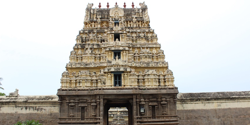 Architectural beauty of Jalagandeswarar Temple with ornate pillars and temple gopuram.