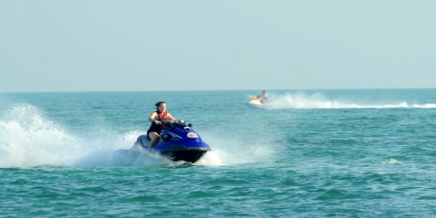 Image of a woman on a jet ski amidst the beautiful turquoise water