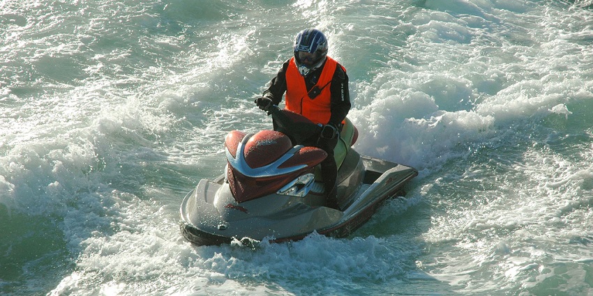 An image of a jet skier racing across the waves at Kashid Beach–one of the best water sports.