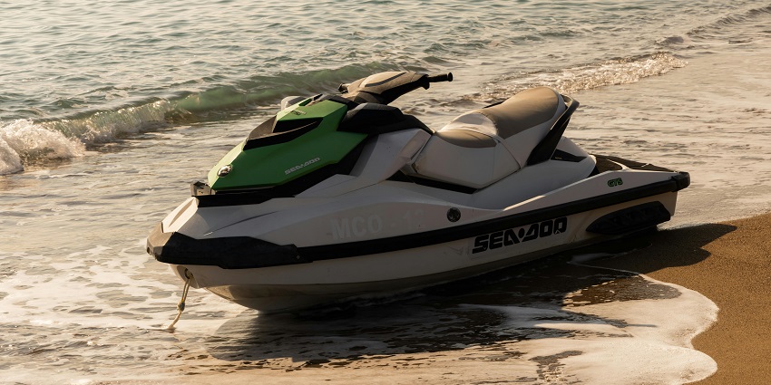 Image of a jet ski resting by the sandy shores of the beach