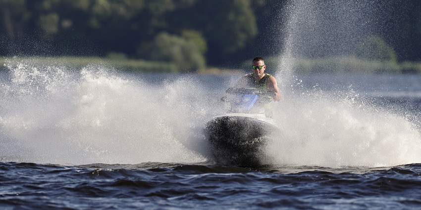 A picture of a rider enjoying Dandi Beach water sports on jet skis in Gujarat.