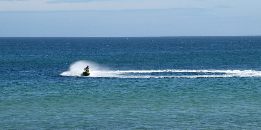 A picture of riders enjoying Nagaon Beach water sports on jet skis in Maharashtra.