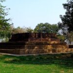 An ancient stone ruins of the Jetavana monastery in Shravasti featuring standing stone walls.