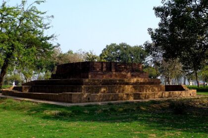 An ancient stone ruins of the Jetavana monastery in Shravasti featuring standing stone walls.