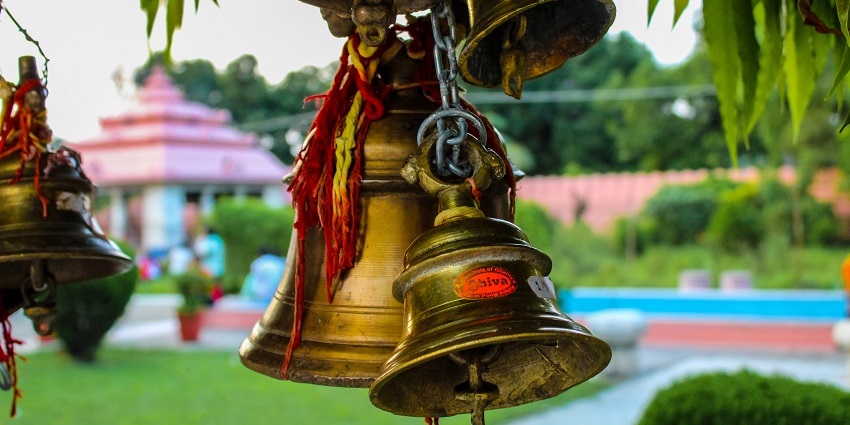 Bells at Jhirna temple located in peaceful surroundings.