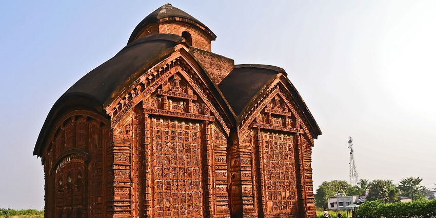 View of the Jorebangla Temple surrounded by lush gardens
