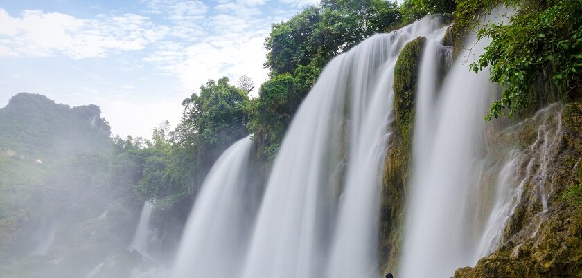 A vibrant view of flowing water of Kaalikesam Waterfalls from torrent amidst rocky terrain.