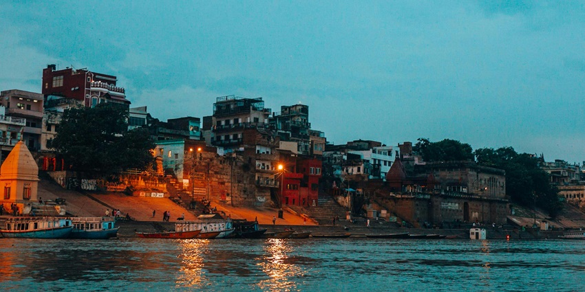 An image showing temples near the waterfront at dusk, resembling Kalamega Perumal Temple.