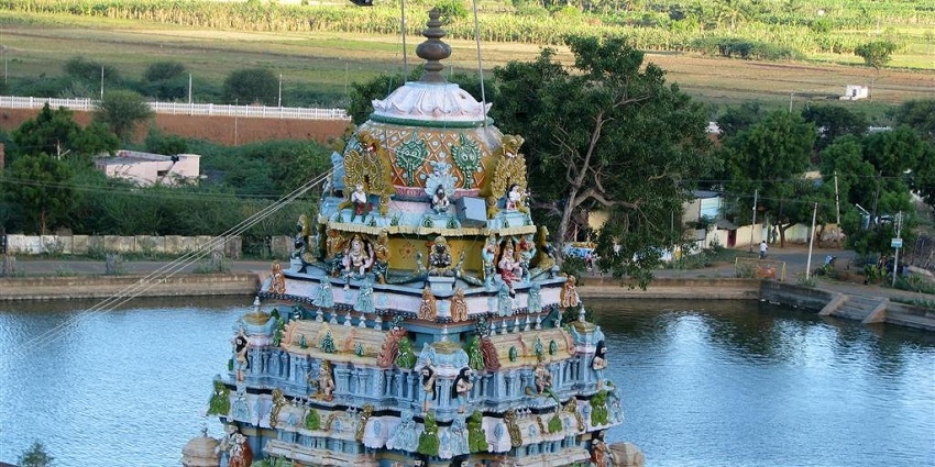 An image showing a view of a Murugan Temple in Tamil Nadu from a nearby rock on a clear day.