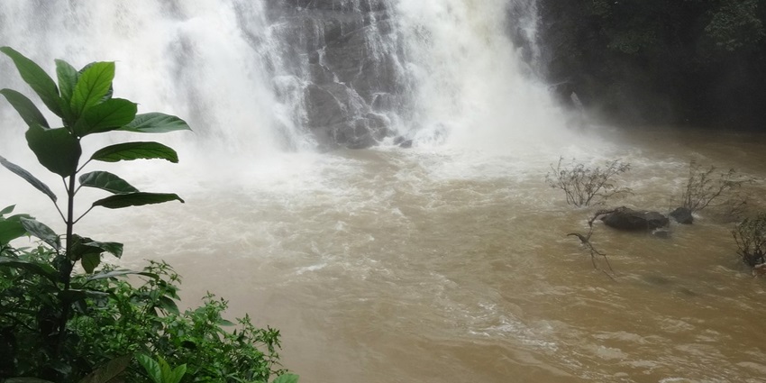 An image of Kalhatty waterfall cascades down rocky cliffs, creating a refreshing mist that fills the air