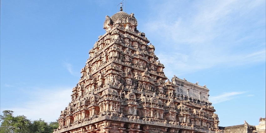 An outer view of a Hindu temple dedicated to Lord Shiva with intricate carvings.