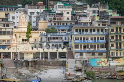 Kalpeshwar Temple shrine amidst mountains and lush greenery located in Uttarakhand.