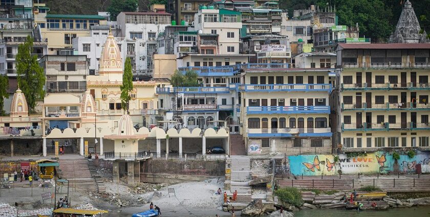 Kalpeshwar Temple shrine amidst mountains and lush greenery located in Uttarakhand.