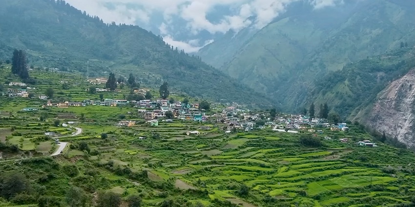 A view of the Kalpeshwar Mahadev temple, set against a mountain backdrop in Uttarakhand.
