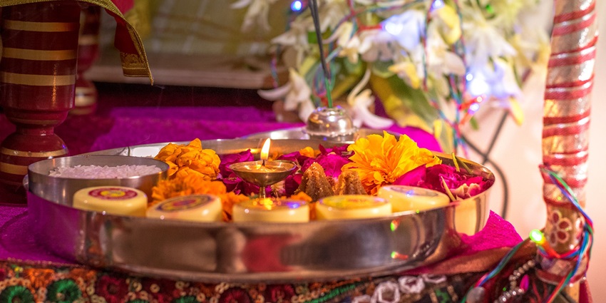 Image of pooja aarti thali decorated with diya, flowers, and other hindu rituals things