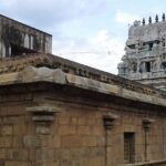 Karkadeswarar Temple with intricate stone carvings, statues, and traditional architecture.