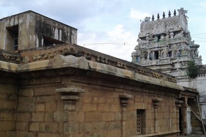 Karkadeswarar Temple with intricate stone carvings, statues, and traditional architecture.