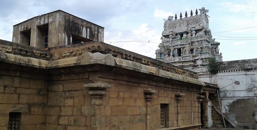 Karkadeswarar Temple with intricate stone carvings, statues, and traditional architecture.