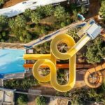 The image shows birds eye view of a waterpark, fun twisty ride - Karnal water parks